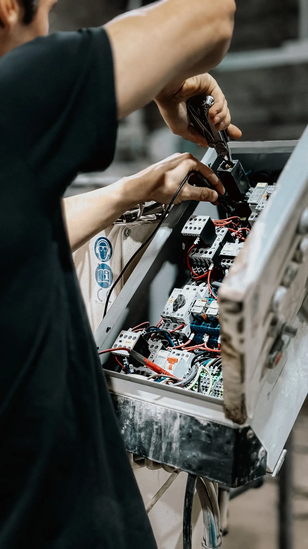 Technician carrying out electrical maintenance